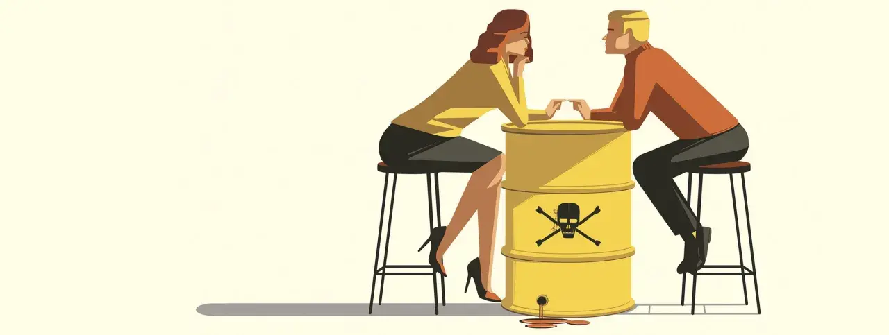 Ein Mann und eine Frau sitzen sich gegenüber, getrennt durch einen gelben Fass mit Totenkopf-Symbol. Die Szene symbolisiert Manipulation in der Beziehung, wo giftige Gefühle die Verbindung vergiften.